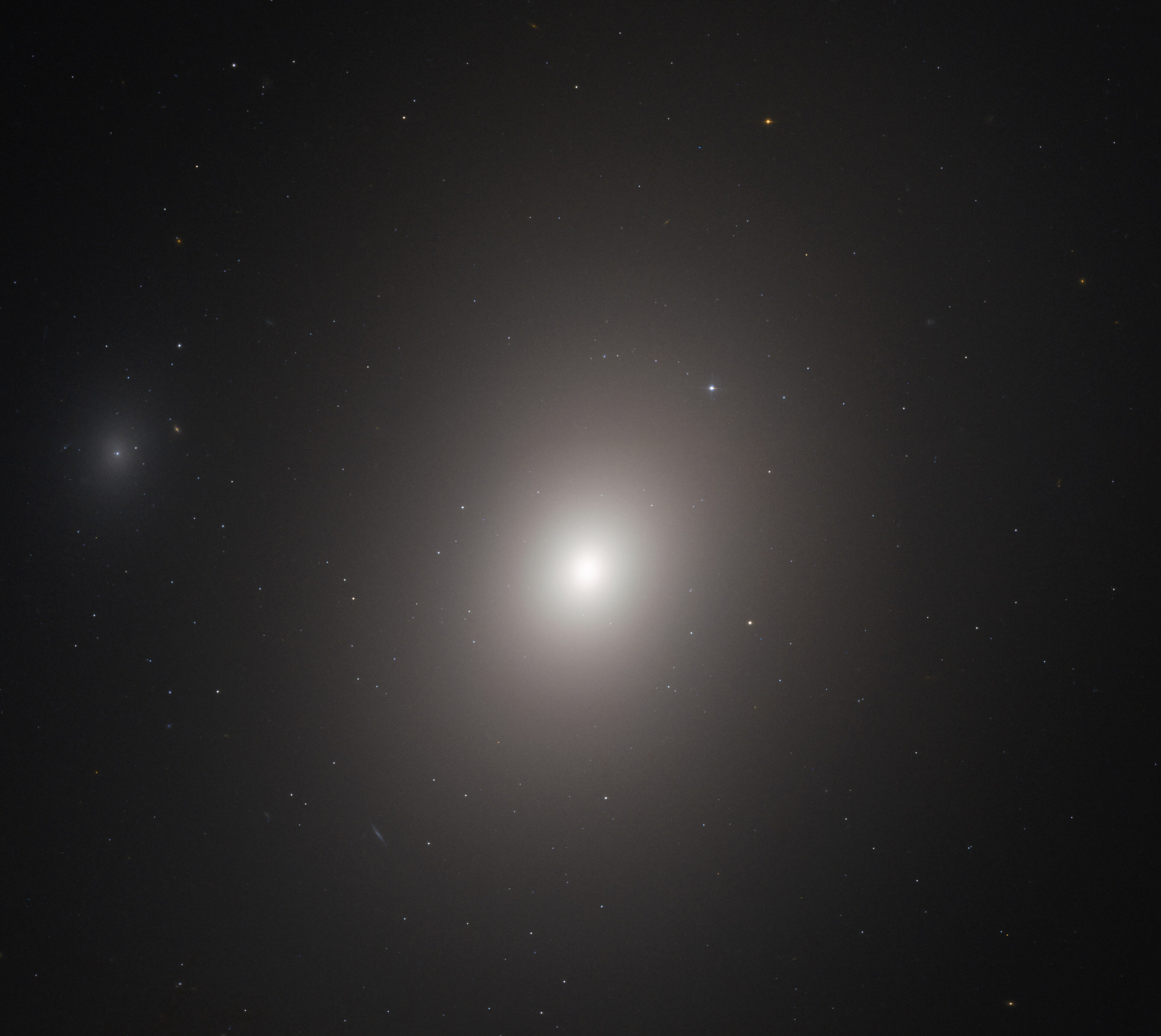 M86, the blueshifted elliptical galaxy at the center of Markarian's Chain, plunging into the Virgo Cluster core at high velocity
