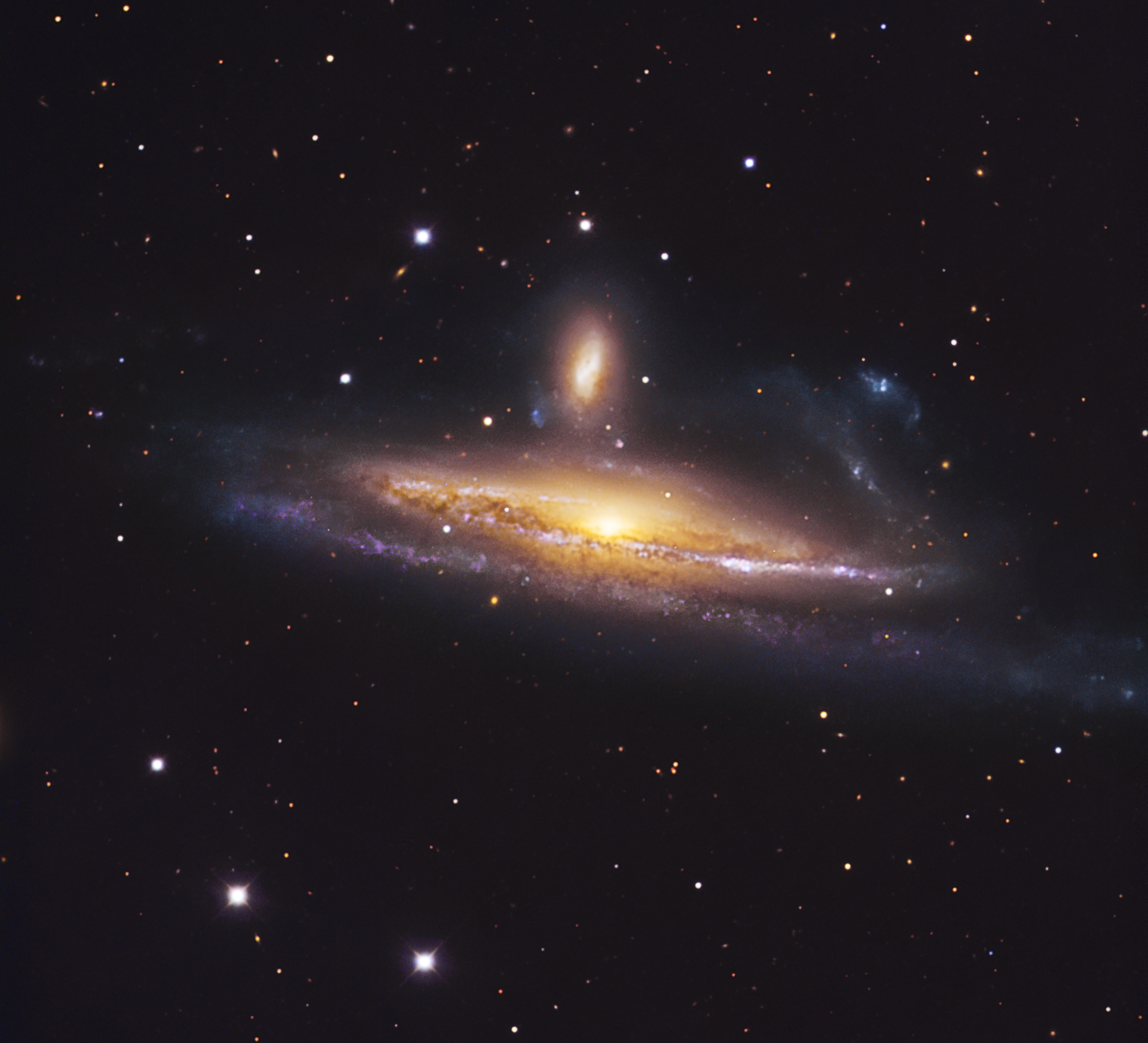 NGC 1532 (Haley's Coronet), a massive spiral galaxy in the act of devouring its smaller companion